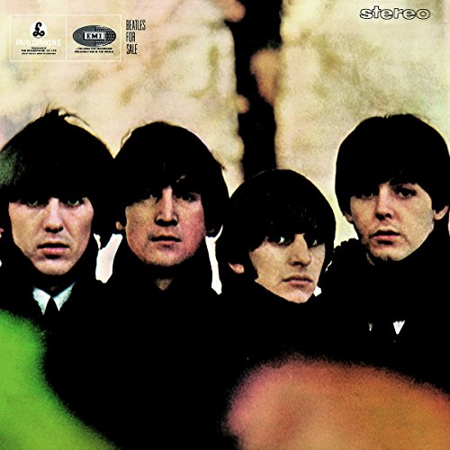 "Album cover featuring a photo of The Beatles, four men with dark hair."