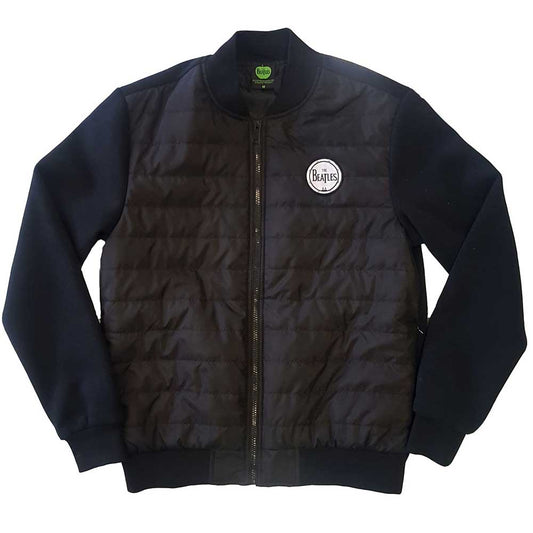 Man wearing a black quilted jacket with The Beatles logo.