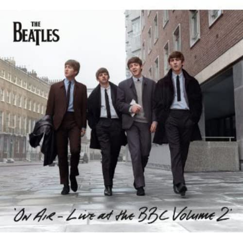 The Beatles in suits walking on a city street, album cover.