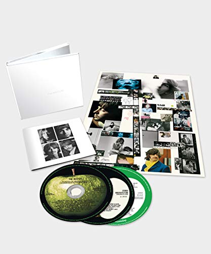 The Beatles CD package with booklet, posters, and two discs.