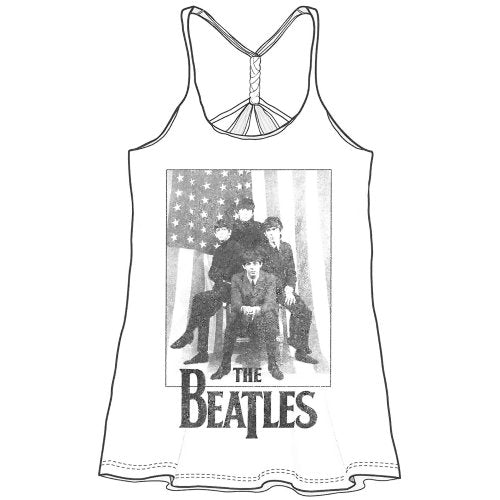 A woman wearing a white tank top featuring The Beatles over an American flag print.