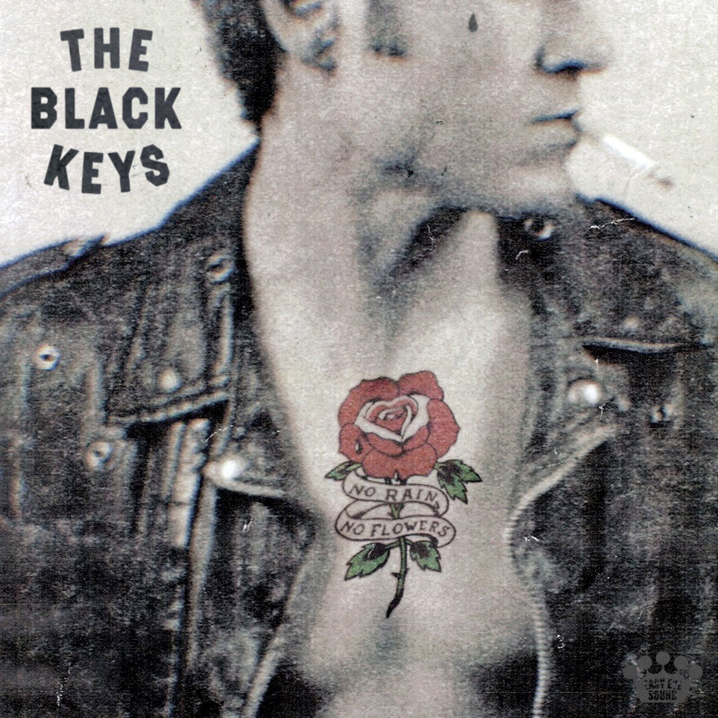 The Black Keys album cover featuring a rose tattoo on a chest.