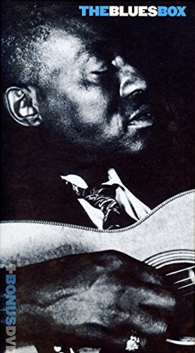 Black and white portrait of a blues musician with a guitar.