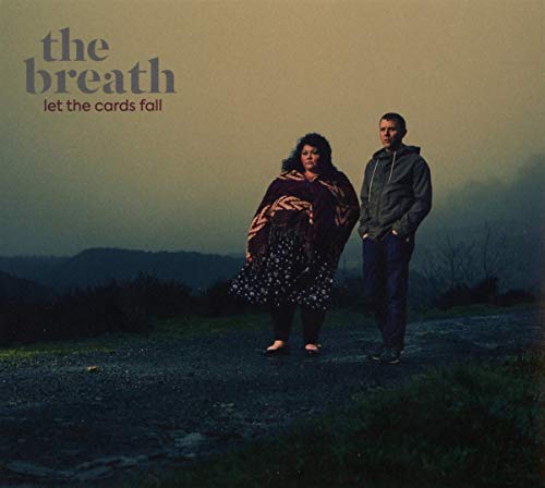 Album cover featuring a woman and man standing outdoors against a misty landscape.