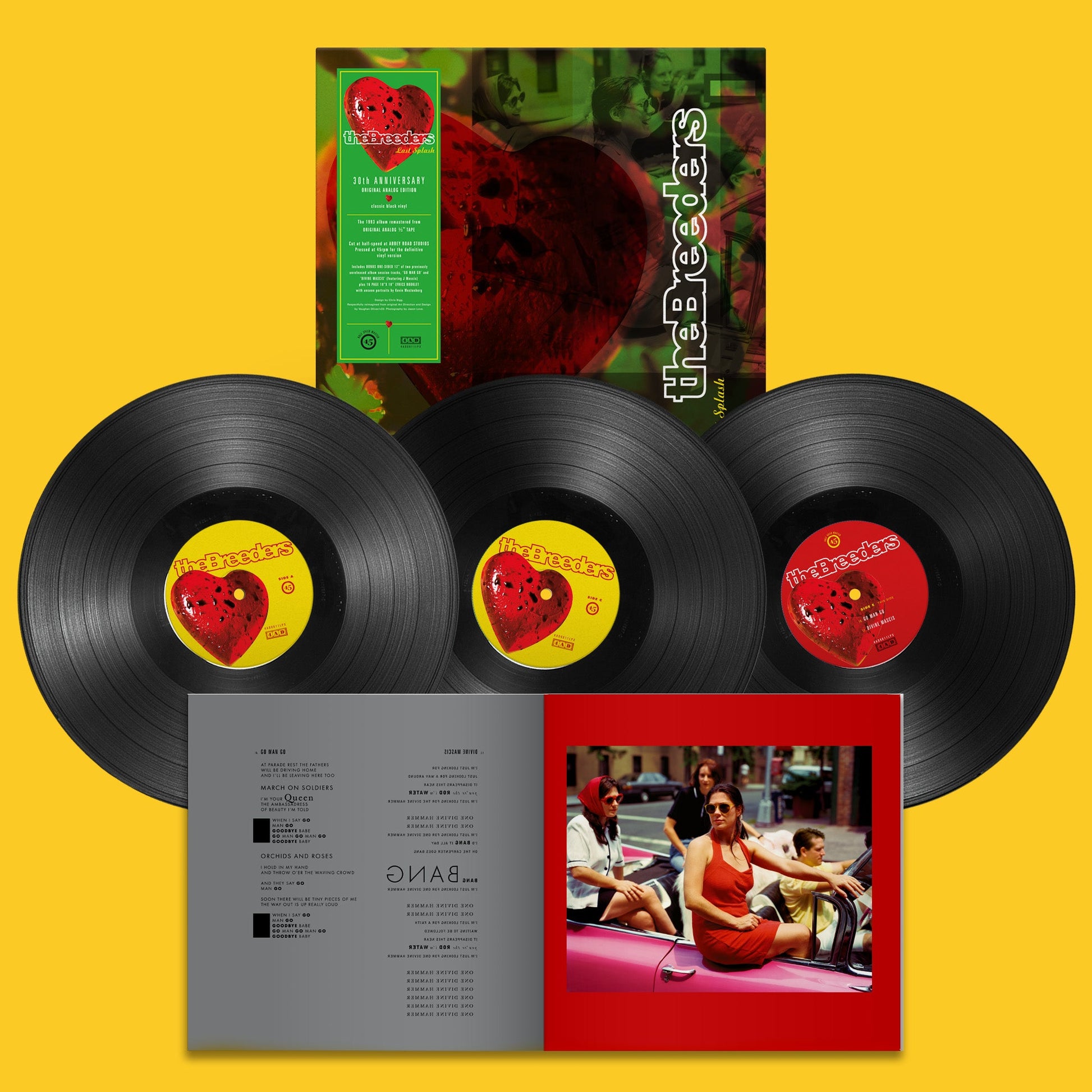 "Three vinyl records with red heart labels and album cover art."