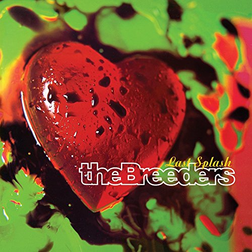 A red heart shape on a bright green background with dark liquid splashes.