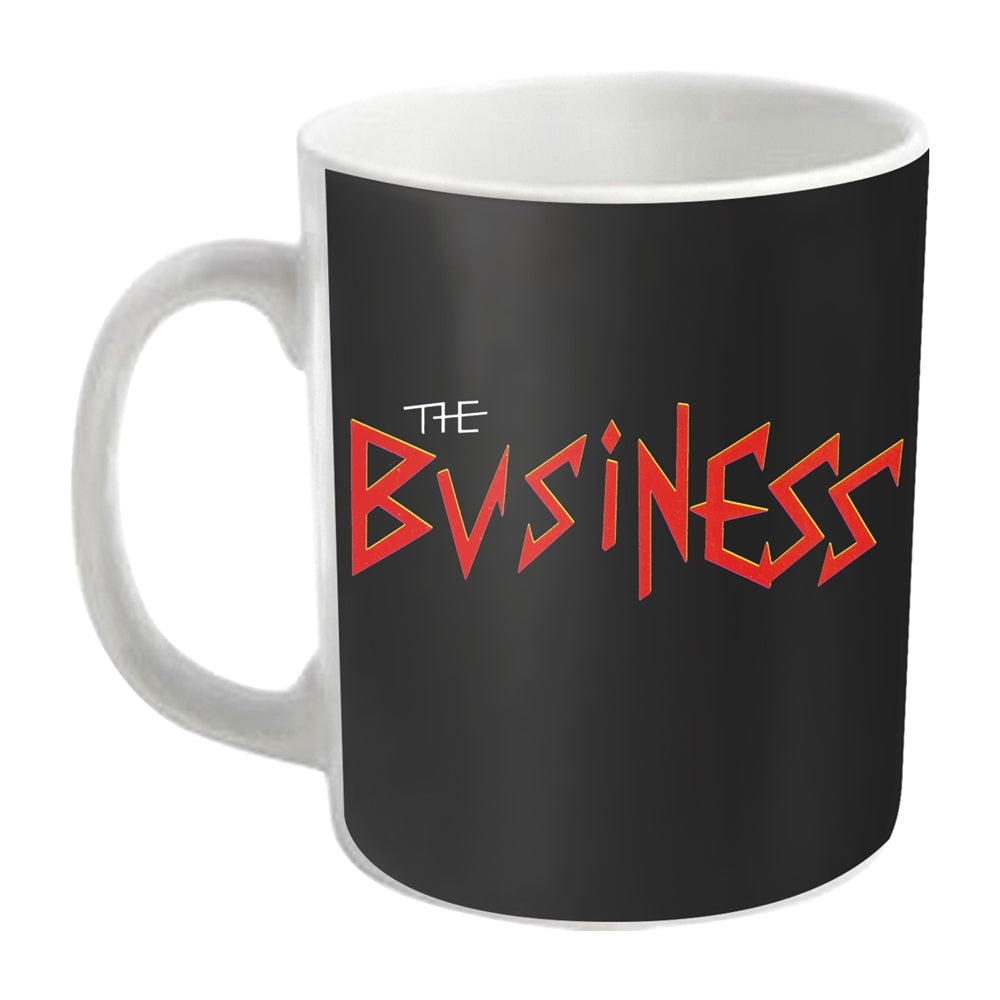 White ceramic mug with red "The Business" band logo on black background.