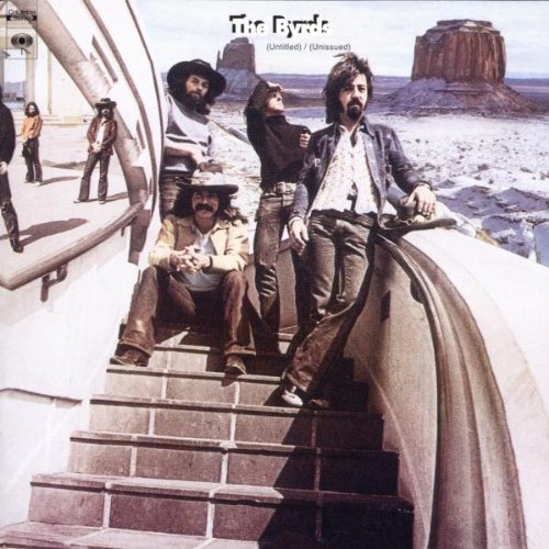 The Byrds band members posing on stairs with a desert landscape backdrop.