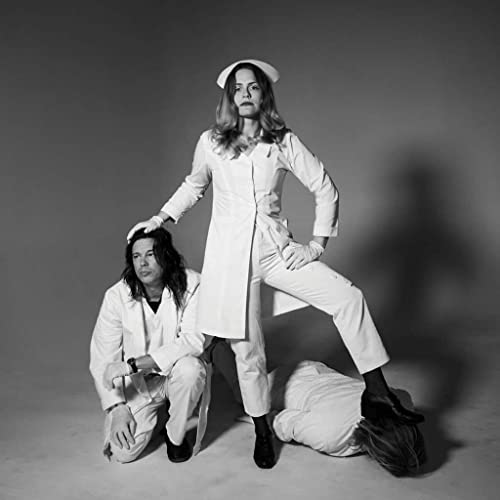 Black and white photo of two people in medical attire.