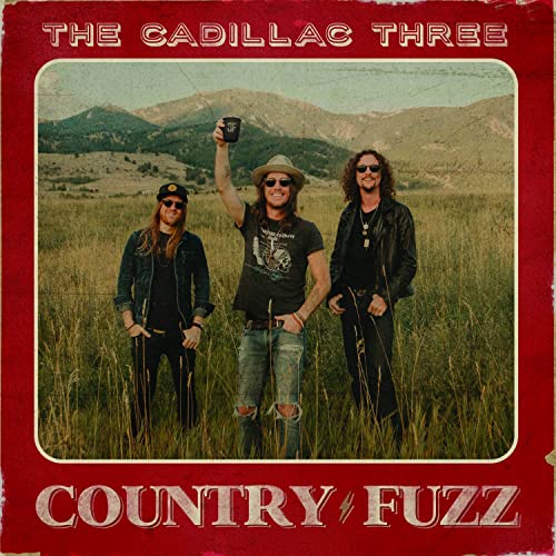 Album cover for Country Fuzz by The Cadillac Three featuring three men in fields.
