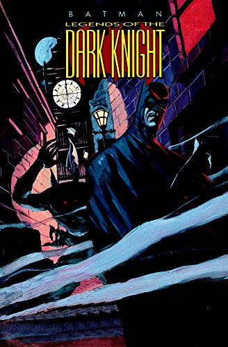 Batman stands near a brick wall and a street lamp, dark and moody.