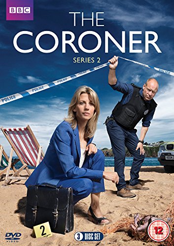 A woman in a blue suit and a man in uniform on a beach.