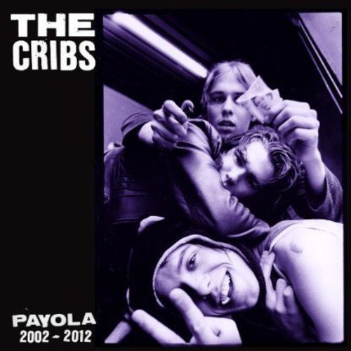 The Cribs "Payola" CD cover: three people in a blurry, dark photo.