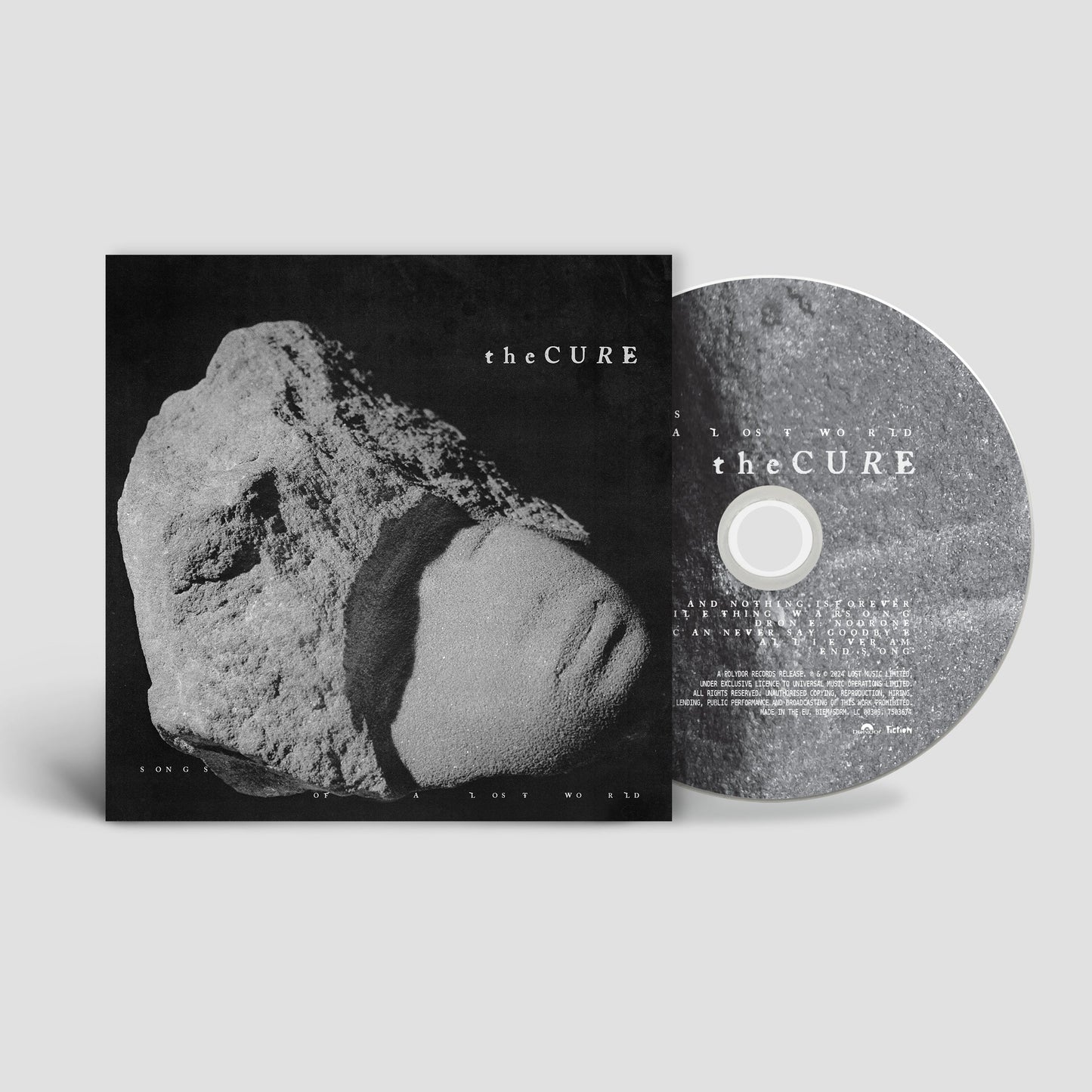 The Cure Songs of a Lost World CD album cover and disc featuring stone imagery.
