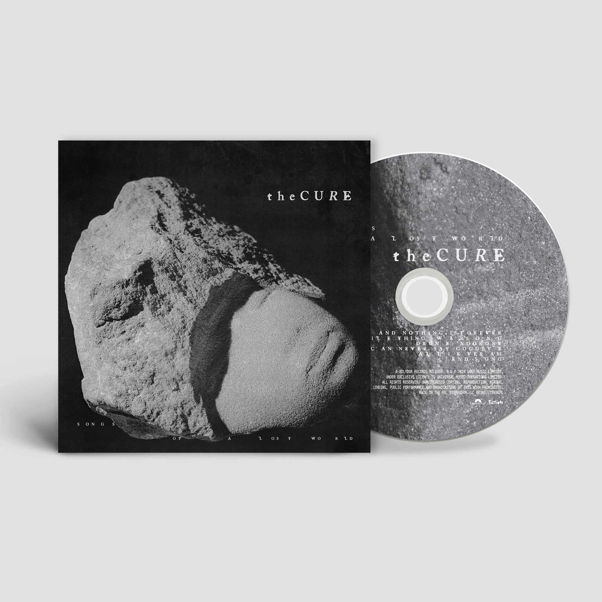The Cure Songs of a Lost World CD album cover and disc featuring stone imagery.