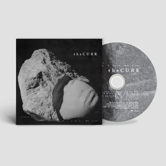 The Cure Songs of a Lost World CD album cover and disc featuring stone imagery.