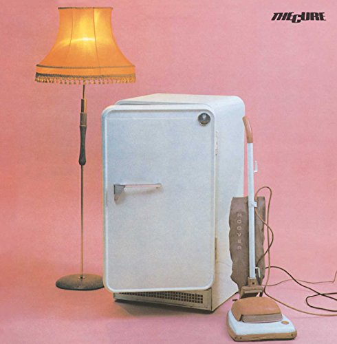 Album cover: a lamp, refrigerator, and vacuum cleaner on pink background.