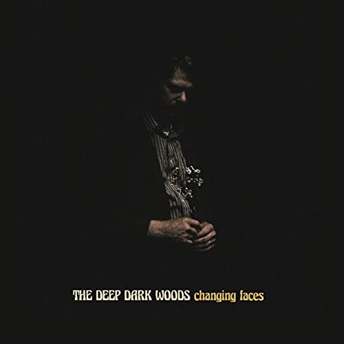 Dark album cover featuring a shadowed figure holding flowers.