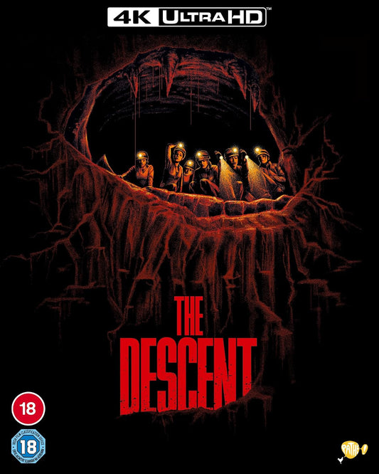Movie poster for "The Descent" showing cavers in a dark cave.