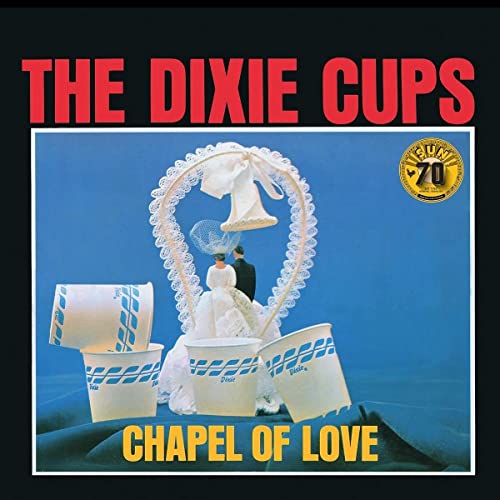 Vinyl cover featuring a bride and groom framed by a lace heart and cups.