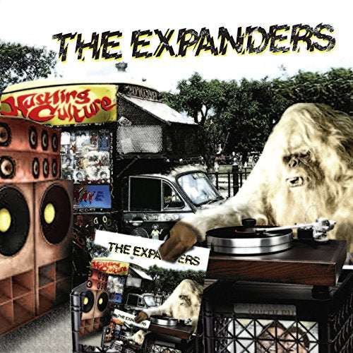 Vinyl album cover with gorilla at record player and large speaker.