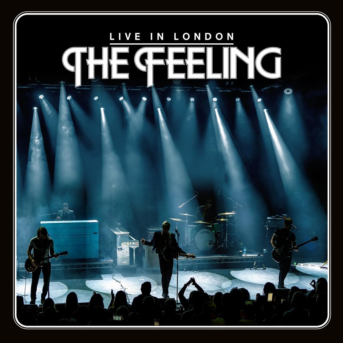 "Album cover with band performing on stage under spotlights, 'The Feeling' text."