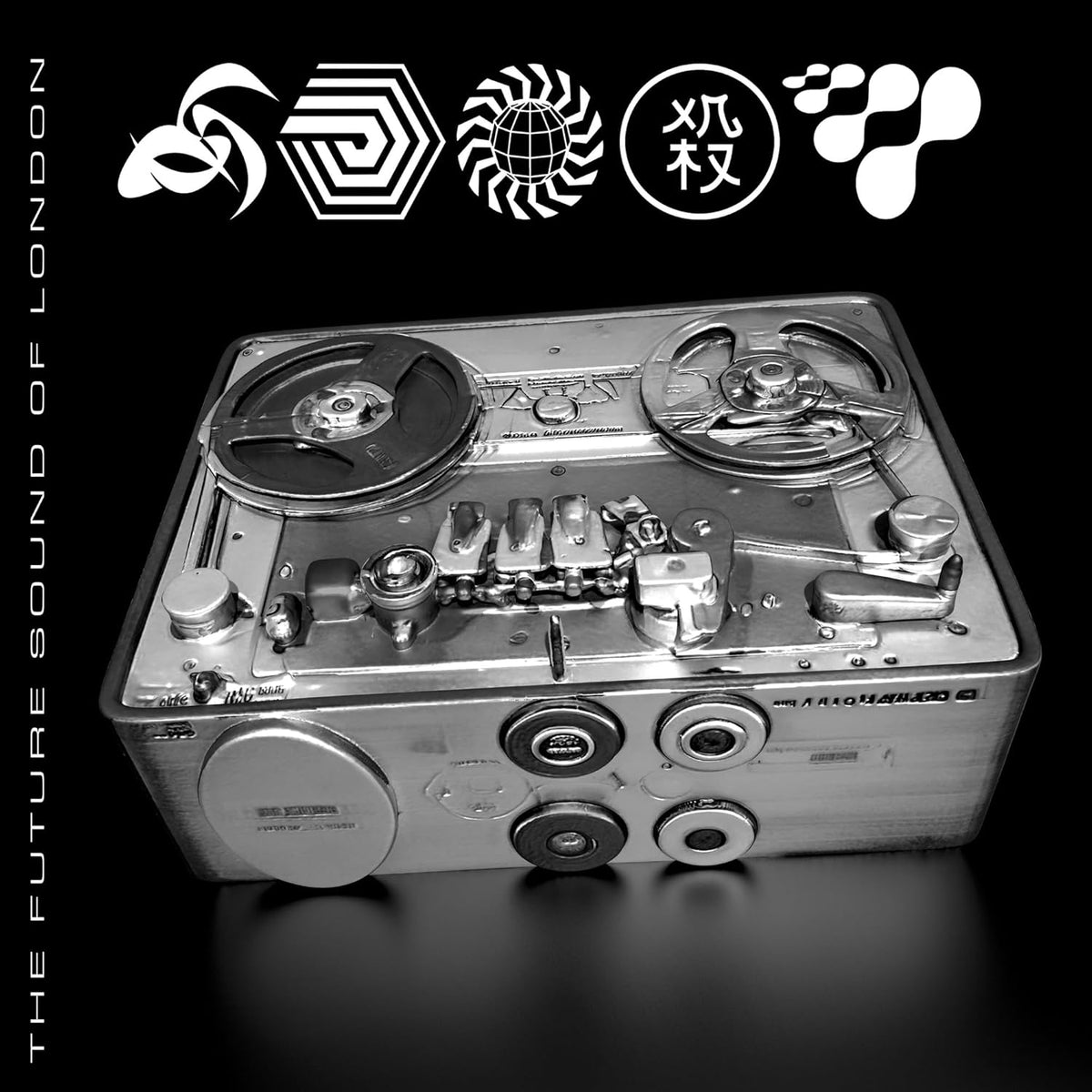 Vinyl record sleeve featuring a metallic, vintage reel-to-reel tape recorder.