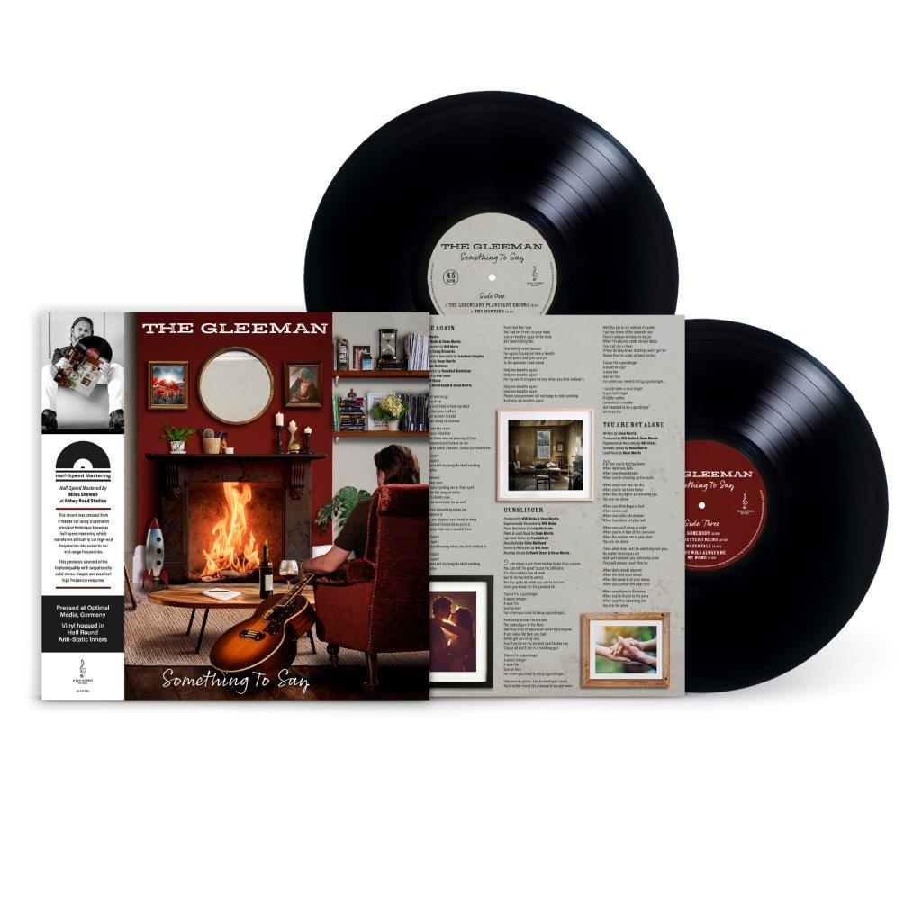 Two black vinyl records with gatefold album cover featuring a fireplace scene.