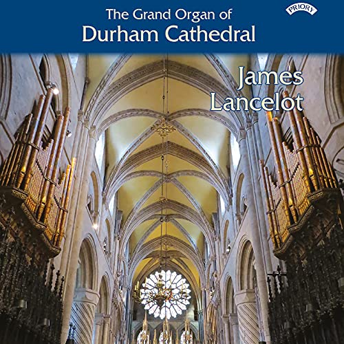 Durham Cathedral organ pipes filling a stone arched interior.