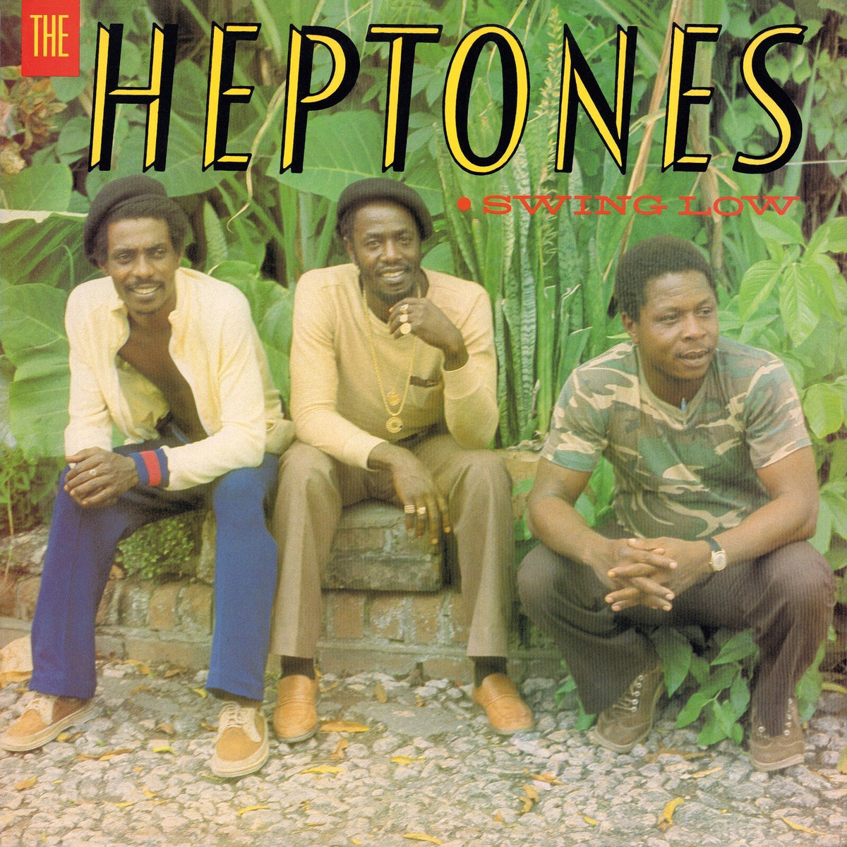 Album cover for The Heptones’ “Swing Low” featuring three men in a garden.