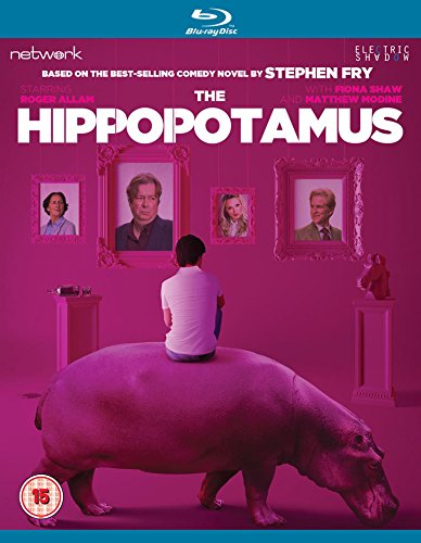 A man sits on a large hippopotamus against a pink background with framed portraits.