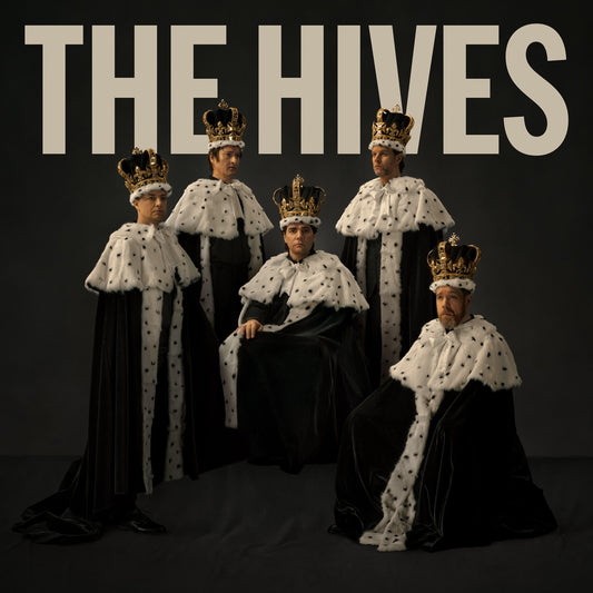Four men wearing crowns and robes pose for a portrait.