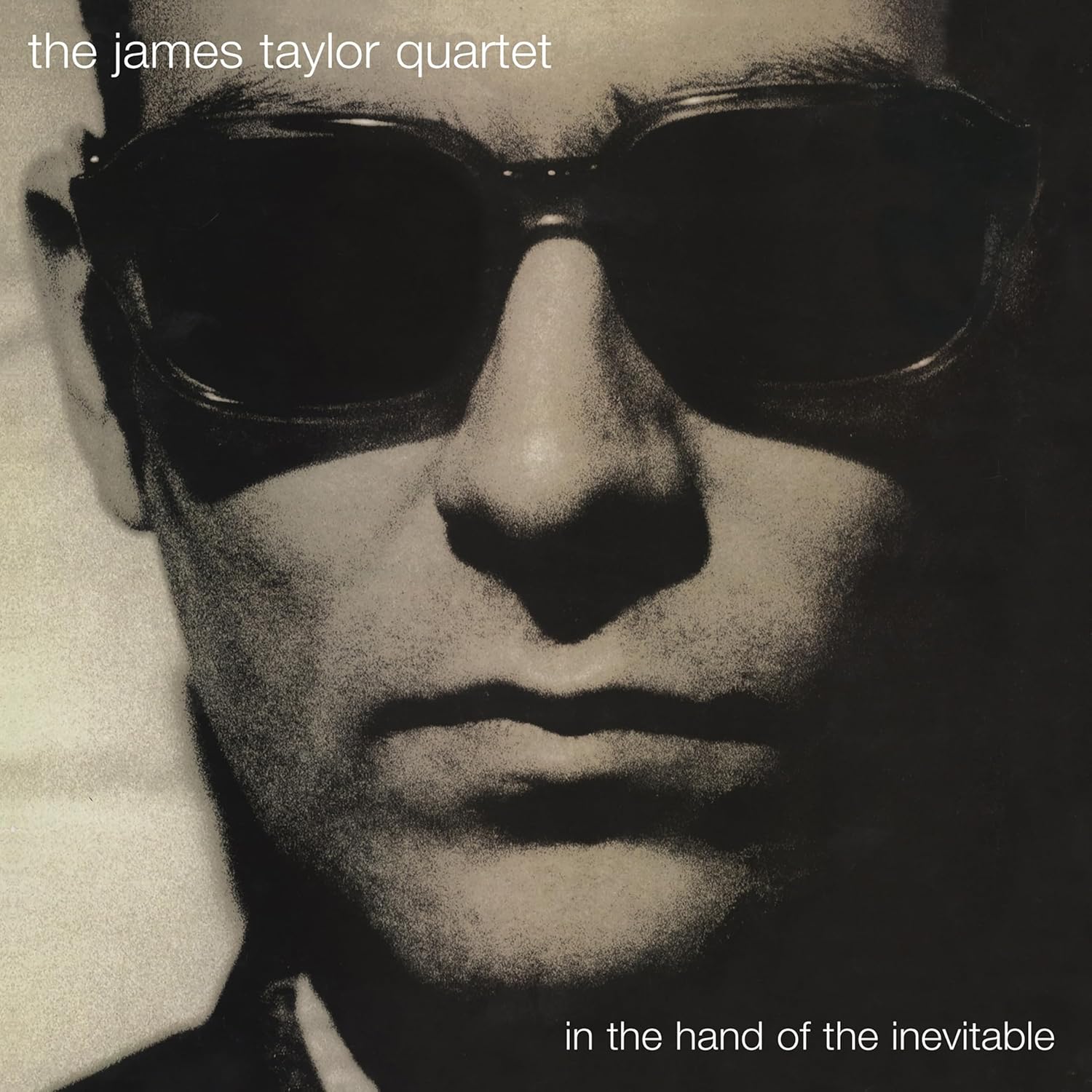 Close-up of a face wearing sunglasses, album cover for The James Taylor Quartet.