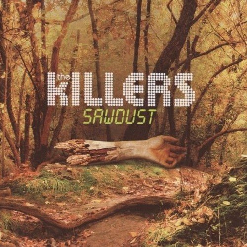 CD cover for The Killers’ “Sawdust” featuring a forest scene.