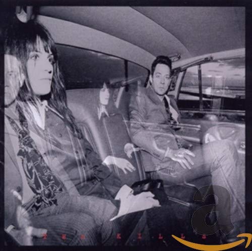 Black and white album cover featuring two people in a car.