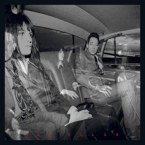 Black and white photo of The Kills band members in a car.