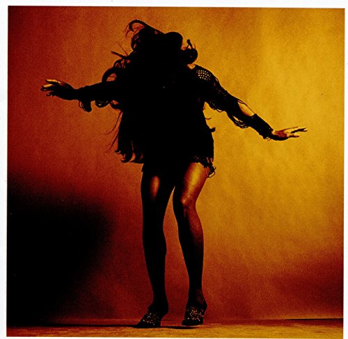 Silhouetted figure in a dynamic pose against a warm orange background.