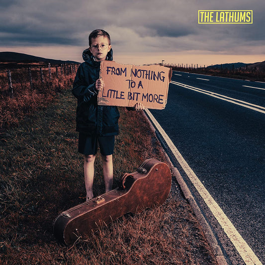 "CD album cover featuring a young boy holding a cardboard sign on a roadside."