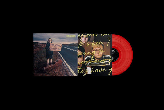 "Album cover with a young boy holding a sign by a road."