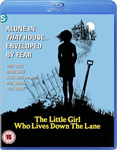 Silhouette of a girl standing near a house with a shovel and teddy bear.
