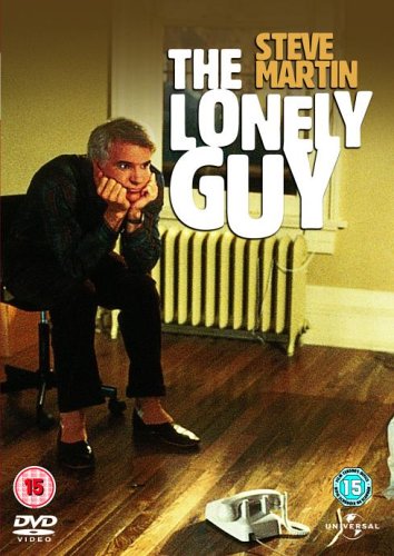 Steve Martin sits on a chair looking sad with a telephone on the floor.