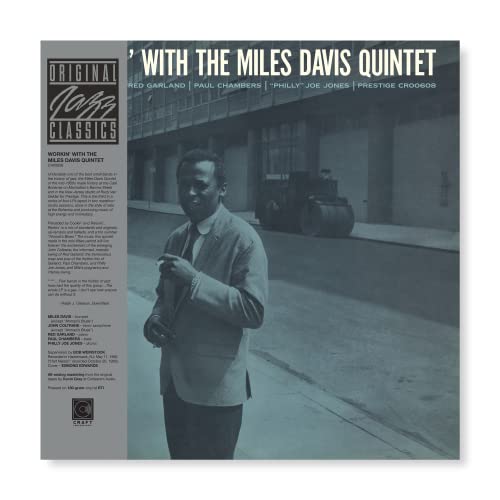 Vinyl record cover featuring Miles Davis in a gray suit, city background.