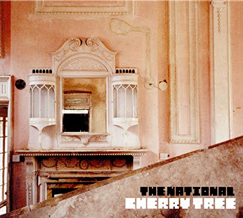 An ornate white fireplace and mirror in a pink room with album text overlay.
