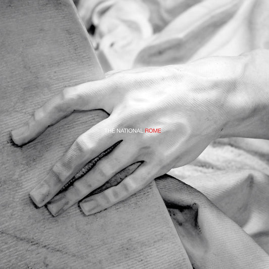 Black and white photo of a hand on stone, album cover for The National’s Rome.