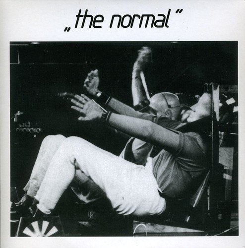 Black and white photo of a person in a chair with arms raised, text above.