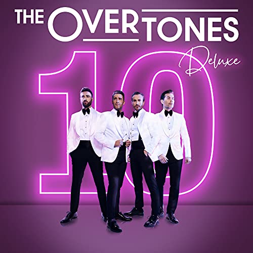 Four men in white tuxedo jackets and black trousers stand before a neon number ten.