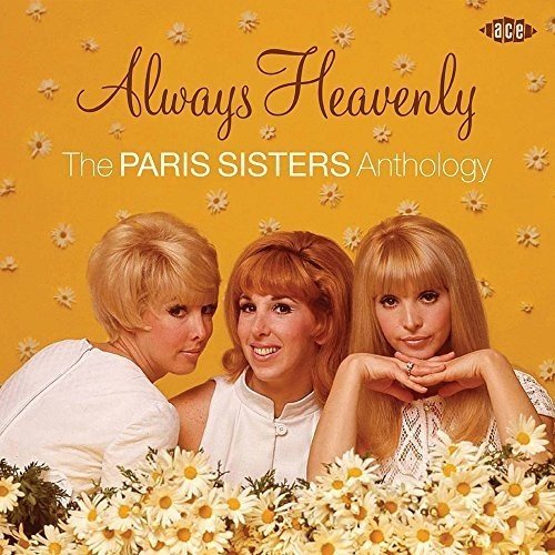 Three women in white tops pose against a yellow daisy-patterned background.