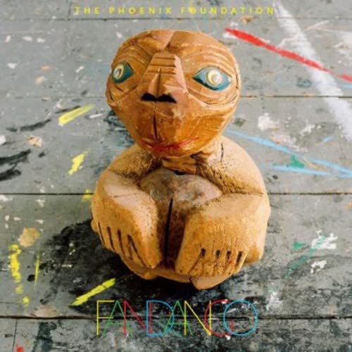 CD cover: wooden mask with blue eyes against a mottled background.