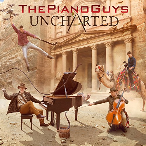 Album cover for The Piano Guys' "Uncharted" featuring musicians and camels.