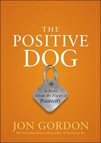 Book cover with orange background, dog tag, and title "The Positive Dog.